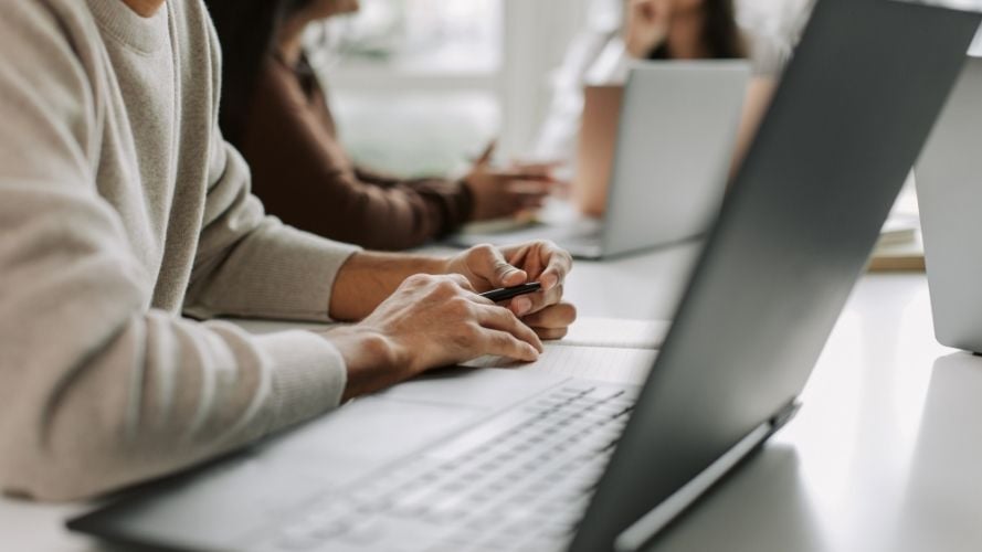 Person watching webinar on laptop