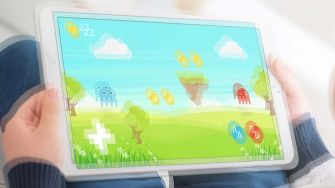 child playing a game on a computer tablet. The image appears as if there is an overlay of the same image, slightly offset, so there are two of everything. This represents how a person with nystagmus might view the same scene. 
