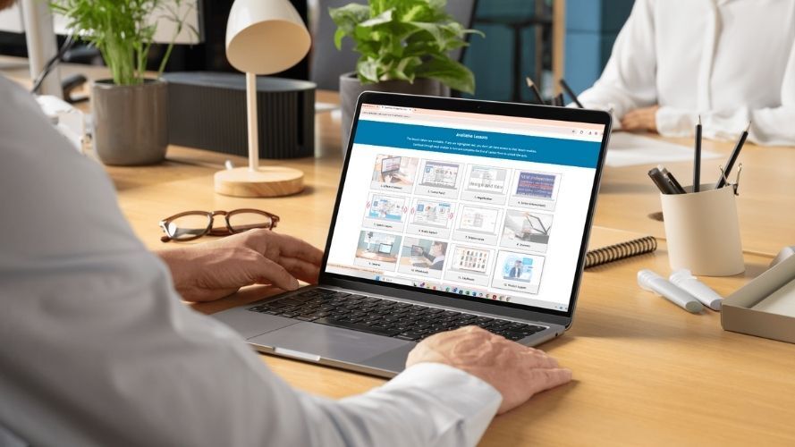 Teacher at desk viewing Dolphin training course